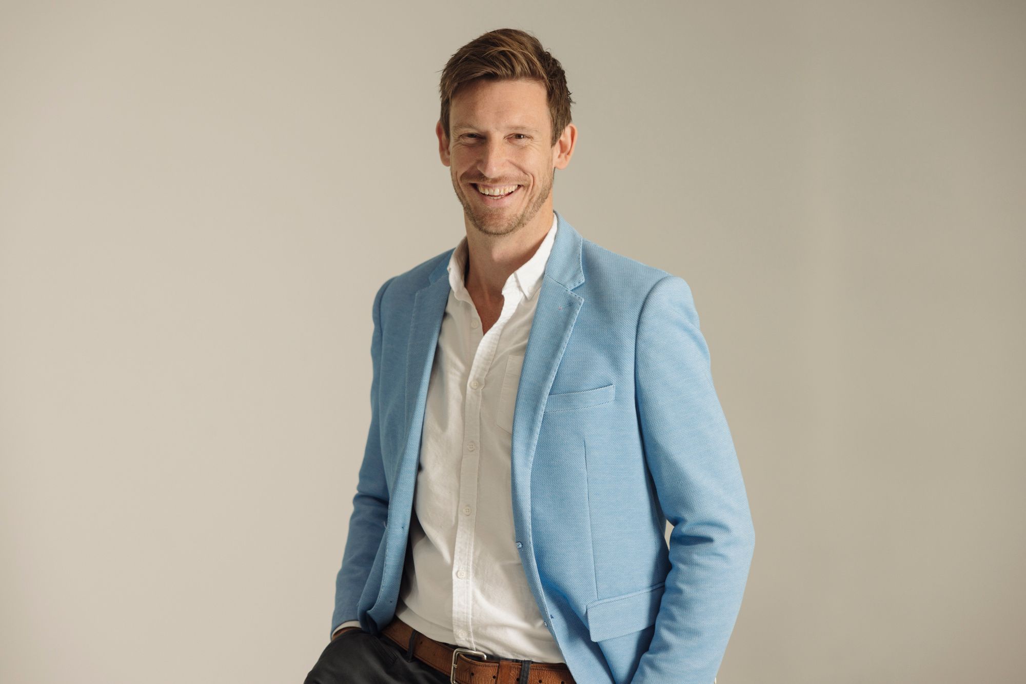 Mat Bankes smiling in a light blue blazer and white shirt
